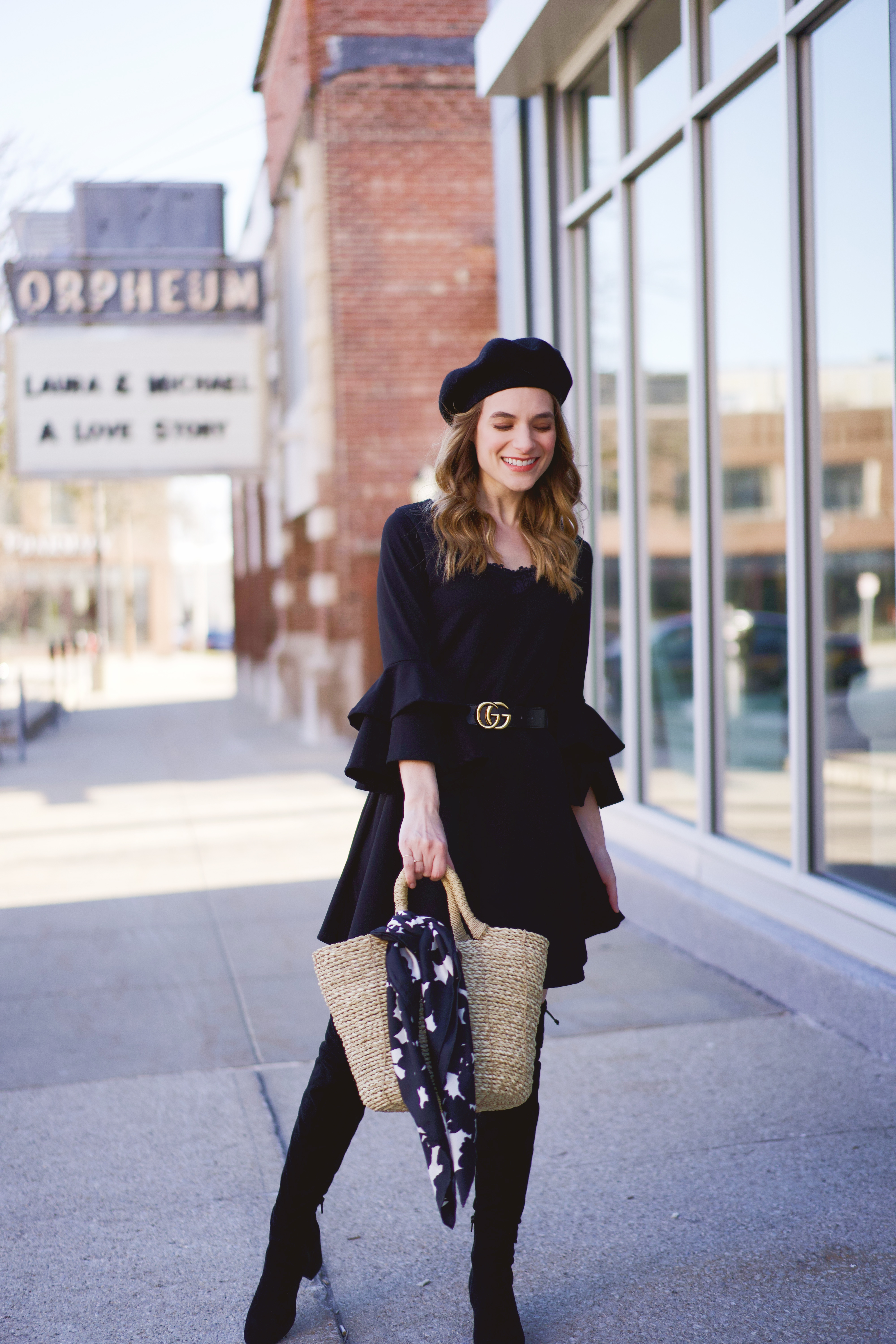 An all black outfit paired with a straw basket bag