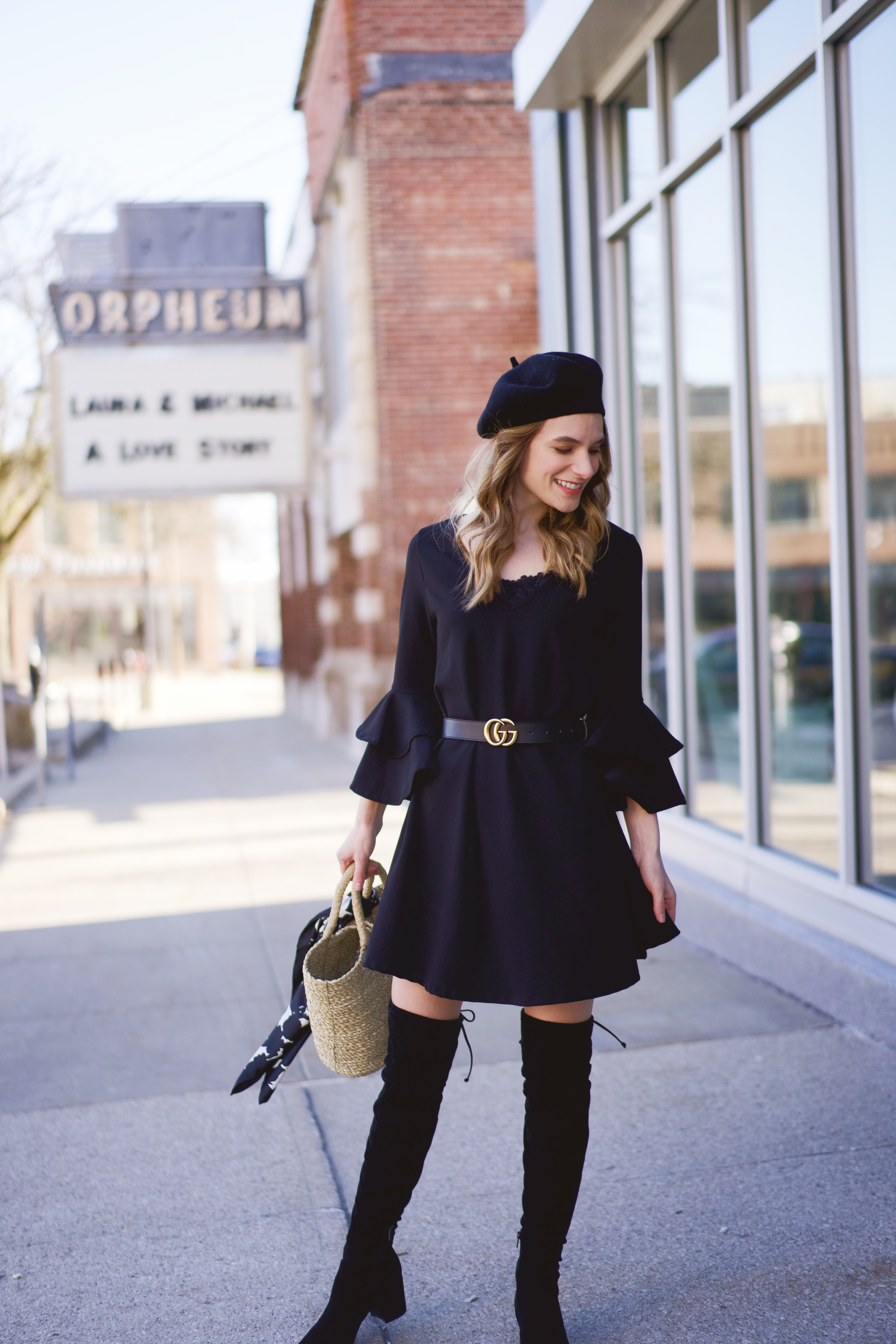A black dress with black over the knee boots 